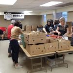 Photograph of people packing boxes of supplies